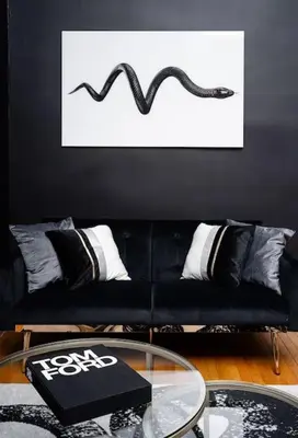a black couch in a living room with a table at Spacious studio in Brooklyn Heights in Brooklyn