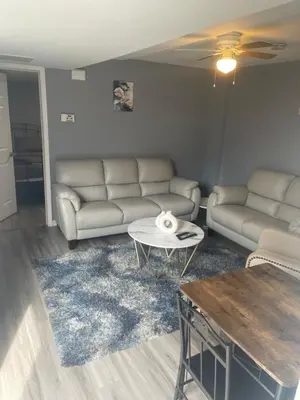 a living room with a couch and a coffee table at Modern one bedroom apartment in Princes Bay