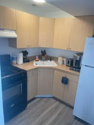 a kitchen with a sink and a stove and a refrigerator at Modern one bedroom apartment in Princes Bay