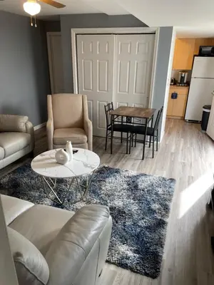 a living room with a couch and a table at Modern one bedroom apartment in Princes Bay