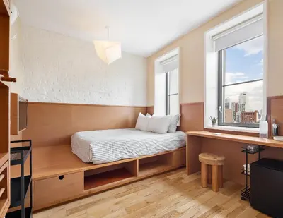 a small bedroom with a bed and a window at UNTITLED at 3 Freeman Alley in New York