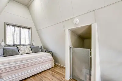 a bedroom with a bed and a window at Dock and Sunroom Waterfront Home Near Kalahari! in Pocono Summit