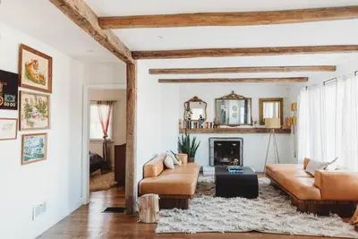 a living room with a couch and a fireplace at Ode to the '70's creative private home with pool in Honey Brook