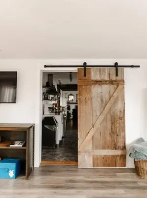 a sliding barn door in a kitchen in a house at Ode to the '70's creative private home with pool in Honey Brook