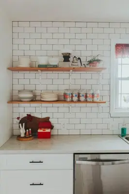 a kitchen with shelves with dishes on the counter at Ode to the '70's creative private home with pool in Honey Brook