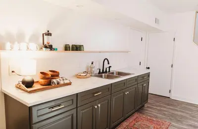 a kitchen counter with a sink and a plate of bread at Ode to the '70's creative private home with pool in Honey Brook