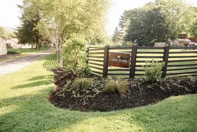 a sign on a fence in a yard at Ode to the '70's creative private home with pool in Honey Brook