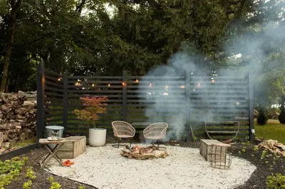 a fire pit with chairs and a grill with smoke at Ode to the '70's creative private home with pool in Honey Brook