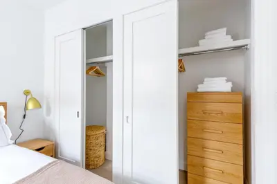 a bedroom with a closet with a bed and a dresser at UWS 1BR w Gym Doorman nr Riverside Park NYC-511 in New York
