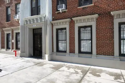 a brick building with black doors and windows at UWS 1BR w Gym Doorman nr Riverside Park NYC-511 in New York