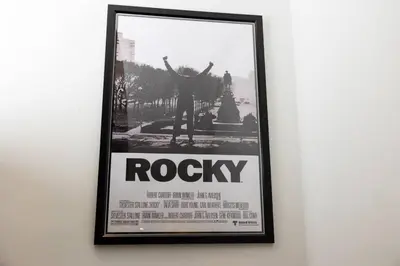 a framed poster of a person on a wall at Thena Hotel- Lux Studio in Philadelphia