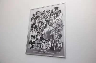 a framed picture of a group of people on a wall at Thena Hotel- Lux Studio in Philadelphia