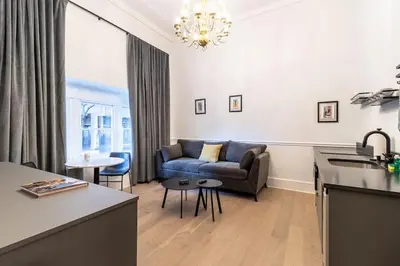 a living room with a couch and a table at Thena Hotel - Ground Floor 1 Bedroom Suite in Philadelphia