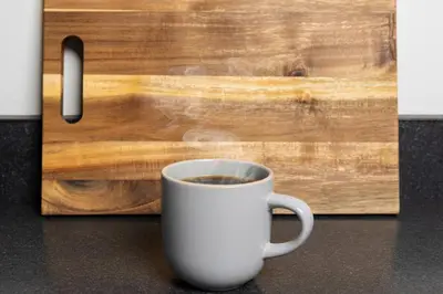 a cup of coffee sitting next to a wooden door at Thena Hotel - Ground Floor 1 Bedroom Suite in Philadelphia
