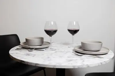 a table with two glasses of red wine on it at Thena Hotel - Ground Floor 1 Bedroom Suite in Philadelphia