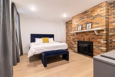 a bedroom with a bed and a fireplace at Thena Hotel - Oversized 1 Bedroom in Philadelphia