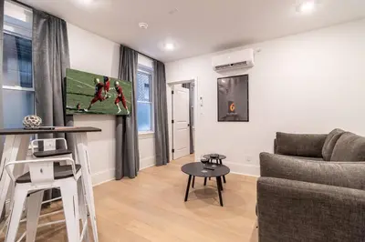 a living room with a couch and a table at Thena Hotel - Oversized 1 Bedroom in Philadelphia