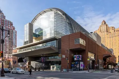 a large building with an arch on a city street at Thena Hotel - Cozy Studio in Philadelphia
