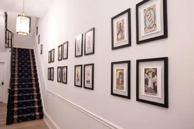 a hallway with framed pictures on a wall at Thena Hotel - Spacious 1 Bedroom - City Center in Philadelphia