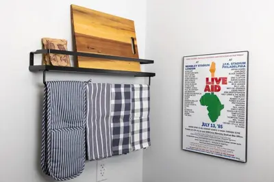 two towels hanging on a wall next to a poster at Thena Hotel - Spacious 1 Bedroom - City Center in Philadelphia