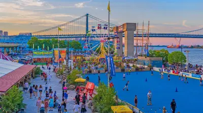 a crowd of people at an amusement park with a ferris wheel at Thena Hotel - Spacious 1 Bedroom - City Center in Philadelphia