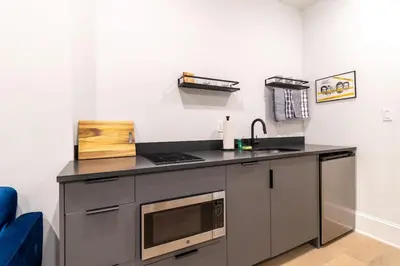 a kitchen counter with a sink and a microwave at Thena Hotel - Beautiful 1 Bedroom in Philadelphia