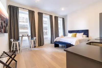 a hotel room with a bed and a table and chairs at Thena Hotel 2nd Floor Studio Unit4 in Philadelphia