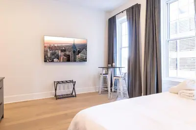 a white bedroom with a bed and a window at Thena Hotel 2nd Floor Studio Unit4 in Philadelphia