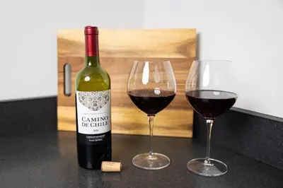 a bottle of wine and two glasses on a counter at Thena Hotel 2nd Floor Studio Unit4 in Philadelphia