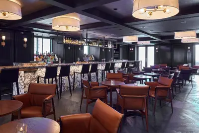 a restaurant with tables and chairs and a bar at The Prince Kitano New York in New York