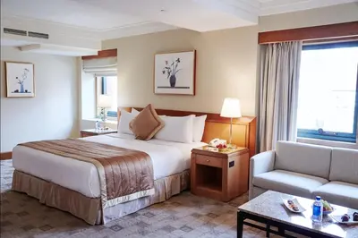 a hotel room with a bed and a couch at The Prince Kitano New York in New York