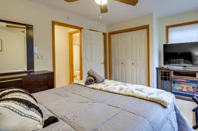 a bedroom with a bed and a flat screen tv at Hot Tub, Game Room! Poconos Home 22 Mi to Slopes in Gouldsboro