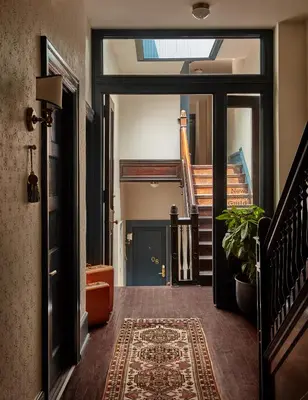 a hallway with a door open to a room with stairs at Guild House Hotel in Philadelphia