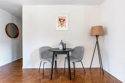 a table in a room with two chairs and a lamp at Chelsea 1BR w Gym Concierge nr Penn Stn MSG NYC-439 in New York