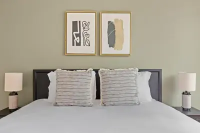 a bedroom with a large white bed with two lamps at 1BR nr Times Sq w Indoor pool Doorman NYC-50 in New York