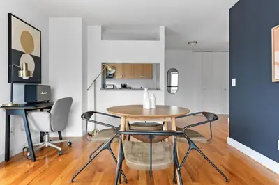 a dining room with a table and chairs at 1BR nr Times Sq w Indoor pool Doorman NYC-50 in New York