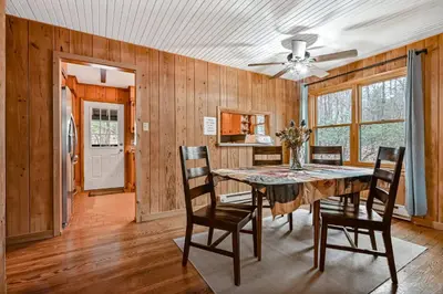 a dining room with a table and chairs at Woodland Cabin Retreat in Lake Harmony