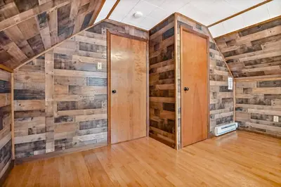 a room with wooden walls and a door at Woodland Cabin Retreat in Lake Harmony