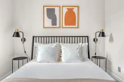 a bedroom with a bed with two lamps and two pillows at W Village 1BR w Elevator WD nr subway NYC-762 in New York