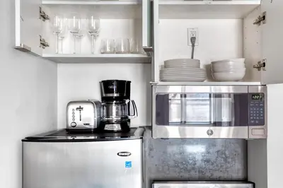 a kitchen with a microwave and a refrigerator at W Village 1BR w Elevator WD nr subway NYC-762 in New York