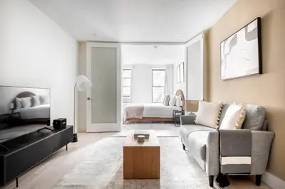a living room with a couch and a bed at East Village 1br w wd nr Union Sq NYC-936 in New York