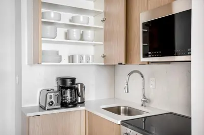 a kitchen with a sink and a coffee maker at East Village 1br w wd nr Union Sq NYC-936 in New York