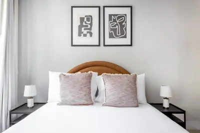 a bedroom with a white bed with two lamps at East Village 1br w wd nr Union Sq NYC-936 in New York