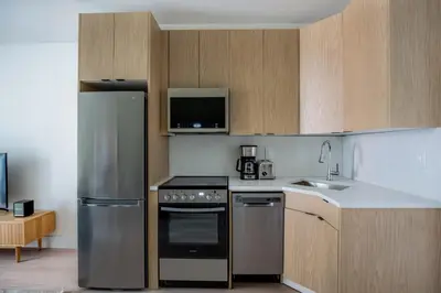a kitchen with stainless steel appliances and wooden cabinets at East Village 1br w wd nr Union Sq NYC-938 in New York
