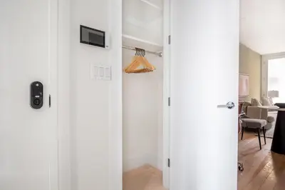 a hallway with white doors and a living room at East Village 1br w wd nr Union Sq NYC-938 in New York