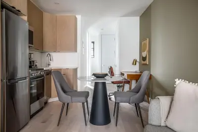 a kitchen with a table and chairs in a room at East Village 1br w wd nr Union Sq NYC-938 in New York