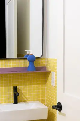 a bathroom with a sink and a mirror at YOWIE Hotel in Philadelphia