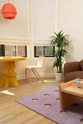 a living room with a chair and a purple rug at YOWIE Hotel in Philadelphia