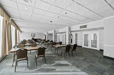 a large room with tables and chairs in it at Executive Inn - Fort Lee in Fort Lee