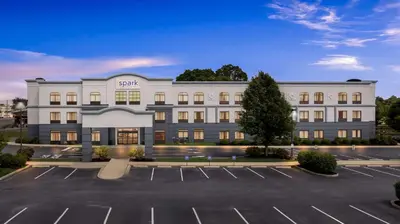 an empty parking lot in front of a hotel at Spark by Hilton Lancaster Dutch Country in Lancaster